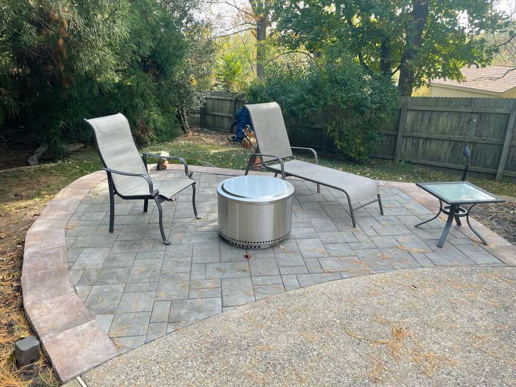 Paver patio with contrasting soldier-course border and a fire pit in West Chester, PA
